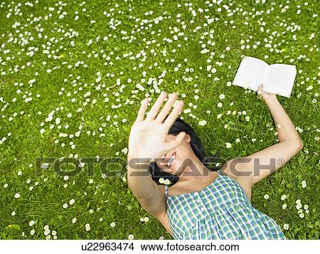 Woman reading a book in the garden View Large Photo Image Picture - Woman reading a book in the garden. Fotosearch