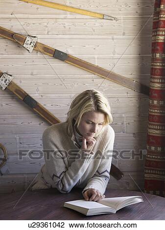 woman reading in ski lodge table View Large Photo Image Stock Image - woman reading in ski lodge table. Fotosearch