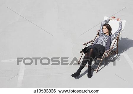 woman relaxing in deck chair View Large Photo Image Stock Photograph - woman relaxing in deck chair. Fotosearch