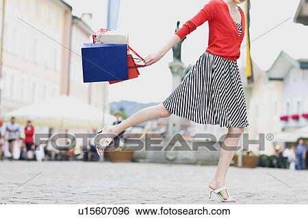 woman runs through a shopping street View Large Photo Image Stock Photograph - woman runs through a shopping street. Fotosearch