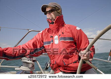Stock Image - Woman sailing yacht. Fotosearch