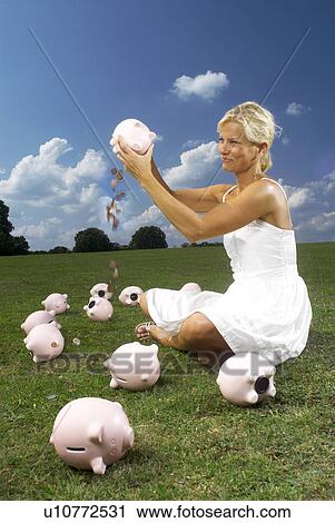 woman shaking piggy bank View Large Photo Image Stock Image - woman shaking piggy bank. Fotosearch