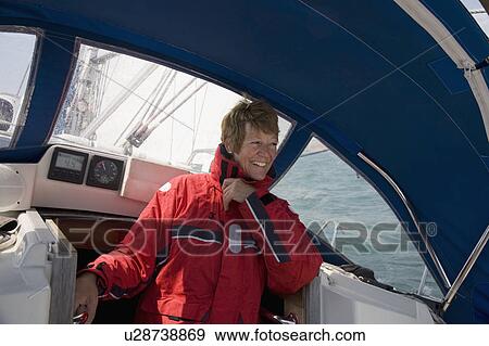 Woman sheltering on yacht View Large Photo Image Stock Photo - Woman sheltering on yacht. Fotosearch