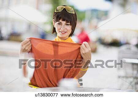 woman shows her brand new clothing View Large Photo Image Stock Photo - woman shows her brand new clothing. Fotosearch