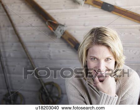 Stock Image - woman sitting at ski lodge table. Fotosearch