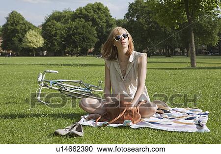 Woman sitting in park View Large Photo Image Stock Image - Woman sitting in park. Fotosearch