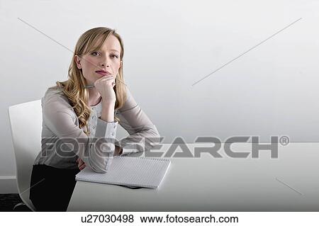 woman sitting with notepad View Large Photo Image Stock Photo - woman sitting with notepad. Fotosearch