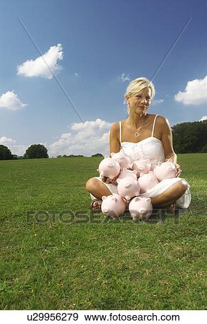 woman sitting with piggy banks View Large Photo Image Stock Photo - woman sitting with piggy banks. Fotosearch