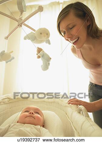 Stock Photo - Woman smiling at baby. Fotosearch
