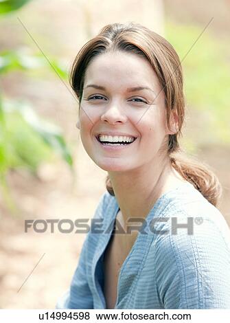 Stock Photo - Woman smiling in country scene. Fotosearch