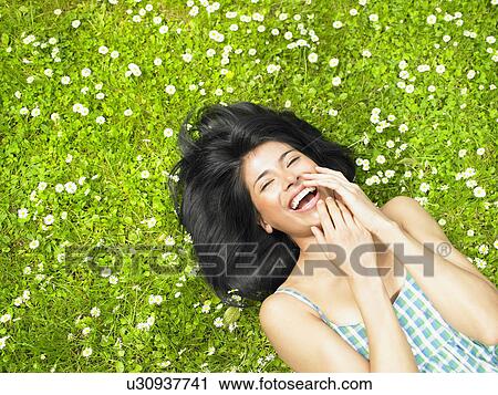 Woman smiling, surrounded by daisies View Large Photo Image Stock Image - Woman smiling, surrounded by daisies. Fotosearch