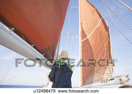 Stock Photo - woman standing on a sailing ship. Fotosearch