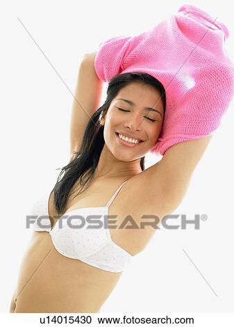 Woman taking off her sweater View Large Photo Image Stock Image - Woman taking off her sweater. Fotosearch