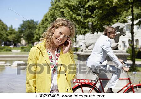 Woman talking on the phone View Large Photo Image Stock Photograph - Woman talking on the phone. Fotosearch