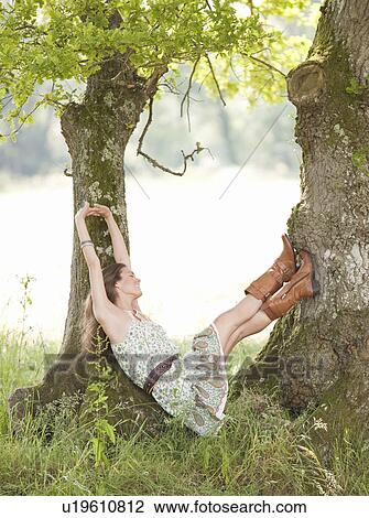 Stock Image - woman under trees. Fotosearch