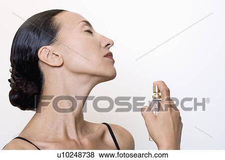 woman using perfume View Large Photo Image Stock Photo - woman using perfume. Fotosearch
