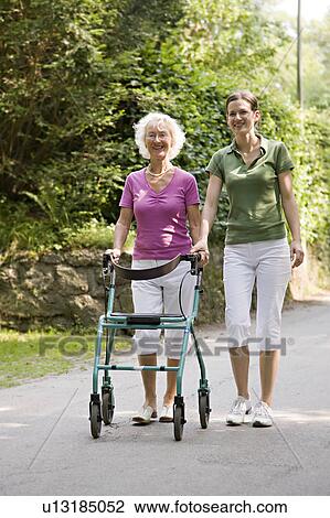 woman walking with senior woman View Large Photo Image Stock Image - woman walking with senior woman. Fotosearch