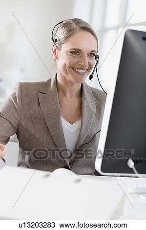 woman with a headset works in an office View Large Photo Image Stock Image - woman with a headset works in an office. Fotosearch