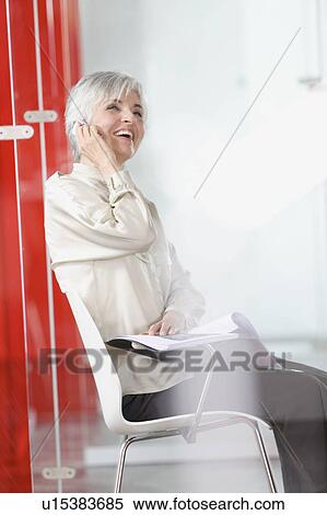 woman with cell-phone in an office View Large Photo Image Stock Photography - woman with cell-phone in an office. Fotosearch