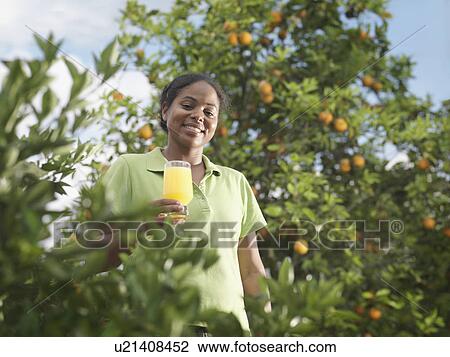 Woman With Glass Of Fresh Orange Juice View Large Photo Image Stock Image - Woman With Glass Of Fresh Orange Juice. Fotosearch