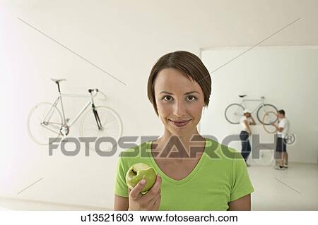 Stock Image - woman with green apple. Fotosearch