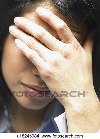 Woman with her hand on her face View Large Photo Image Picture - Woman with her hand on her face. Fotosearch