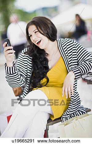 Stock Image - woman with mobile phone. Fotosearch