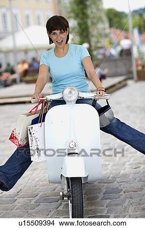 Picture - woman with motor scooter. Fotosearch