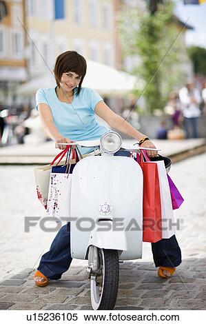 Stock Photography - woman with motor scooter. Fotosearch