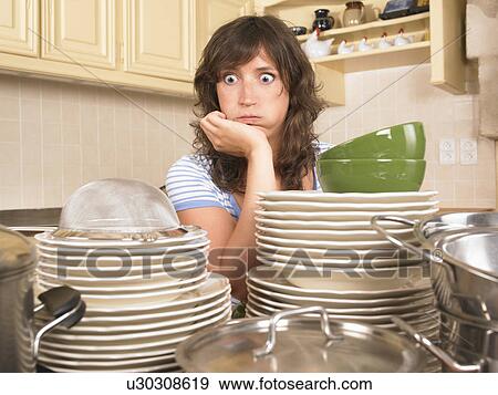 Stock Photo - woman with piles of washing up. Fotosearch