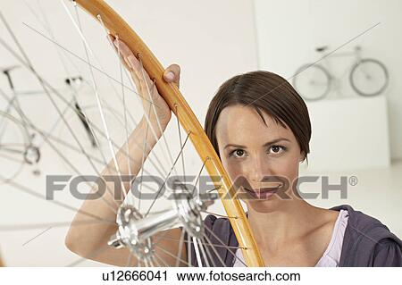 woman with wheel in bikestore View Large Photo Image Stock Image - woman with wheel in bikestore. Fotosearch