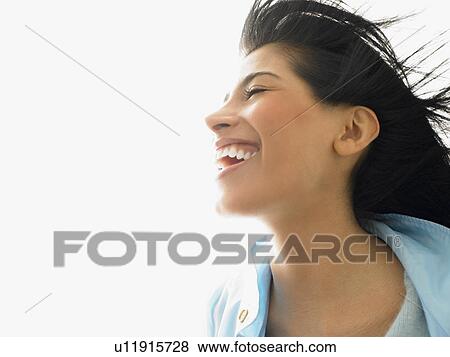 Woman with wind in her hair, smiling View Large Photo Image Stock Photo - Woman with wind in her hair, smiling. Fotosearch