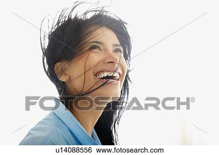 Stock Photograph - Woman with wind in her hair, smiling. Fotosearch