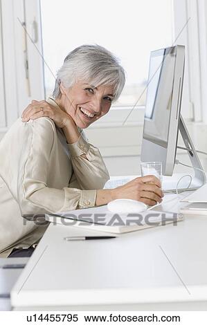 Stock Photography - woman working in an office. Fotosearch