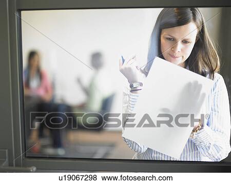 Stock Photo - woman writing against window. Fotosearch