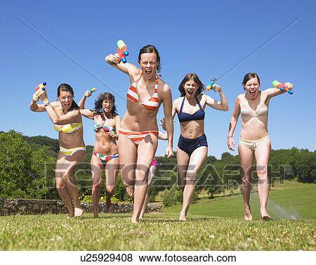 women charging with water guns View Large Photo Image Stock Photo - women charging with water guns. Fotosearch
