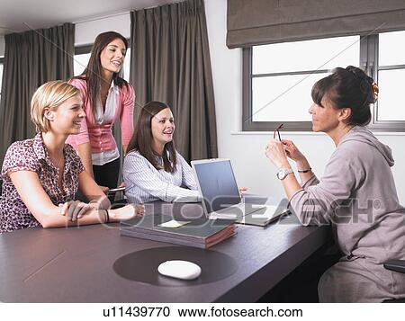 Stock Image - women in a reunion at the office. Fotosearch