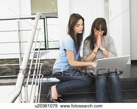 Stock Photo - women on stairs with laptop. Fotosearch