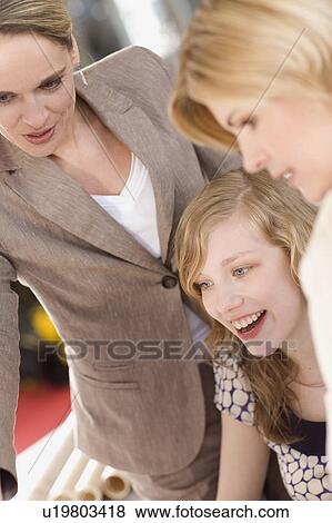 Stock Photo - women teaching something to a trainee. Fotosearch