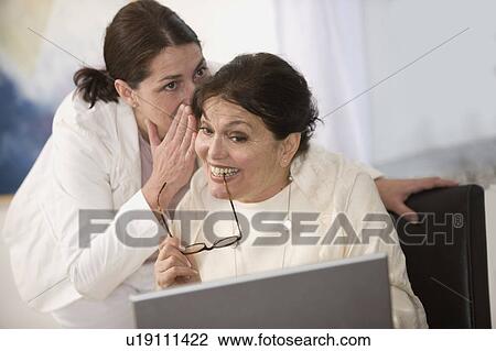 Women whispering and laughing View Large Photo Image Stock Image - Women whispering and laughing. Fotosearch