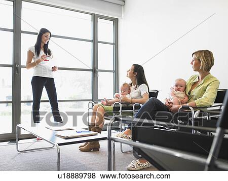 Stock Photo - women with babies, learning. Fotosearch