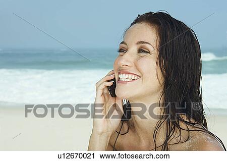 Women with mobile phone on beach View Large Photo Image Stock Image - Women with mobile phone on beach. Fotosearch