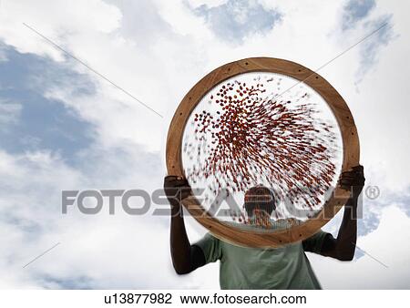 Stock Image - Worker Sieving Coffee Beans. Fotosearch