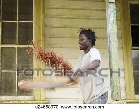 Stock Image - Worker Sieving Coffee Beans. Fotosearch