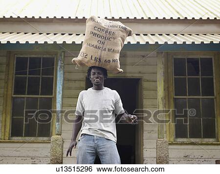 Stock Photograph - Worker With Sack Of Coffee Beans On Head. Fotosearch
