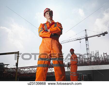 Stock Photo - Workers And Cranes. Fotosearch