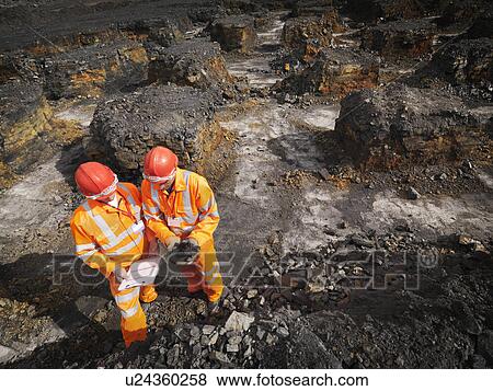 Stock Photo - Workers Inspecting Coal In Mine. Fotosearch