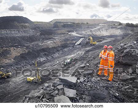 Stock Photo - Workers Looking Over Coal Mine. Fotosearch