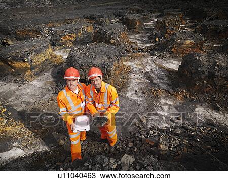 Stock Image - Workers With Clipboard In Coal Mine. Fotosearch