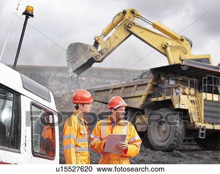 Stock Image - Workers With Digger In Coal Mine. Fotosearch